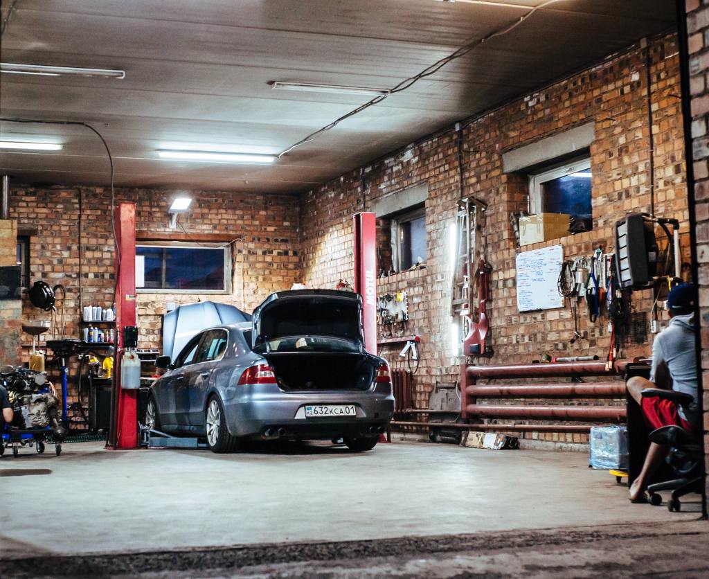 A car getting fixed in a garage.