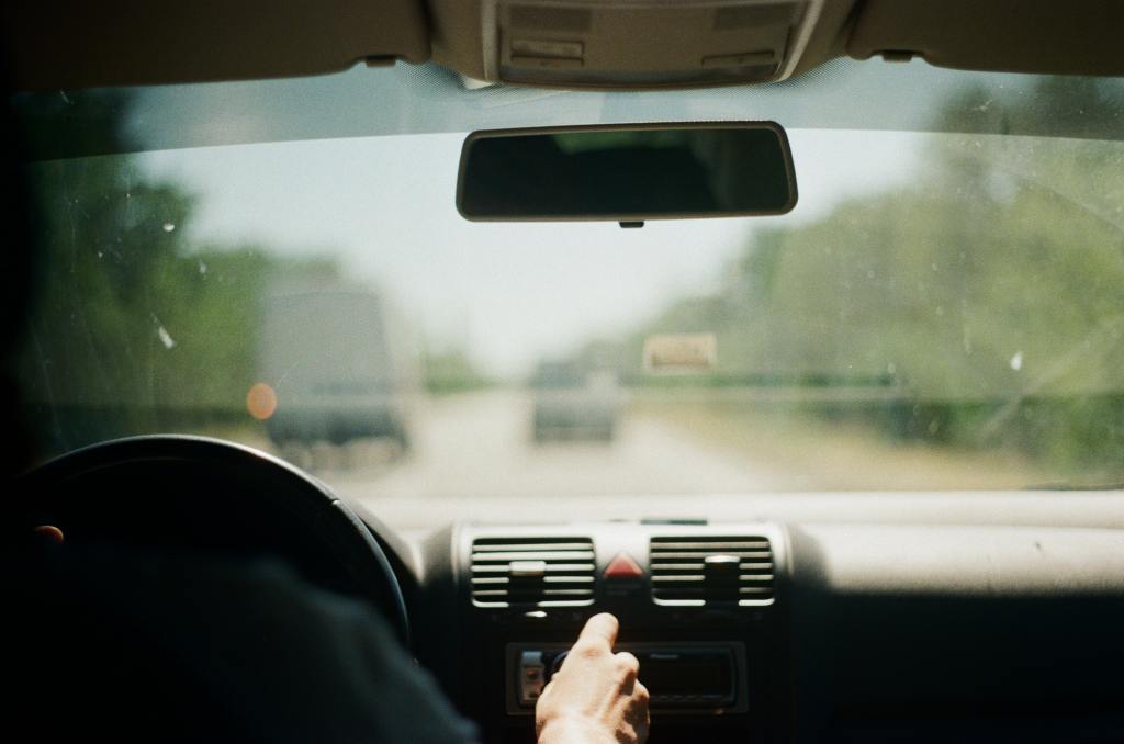 A driver behind the wheel of their car.