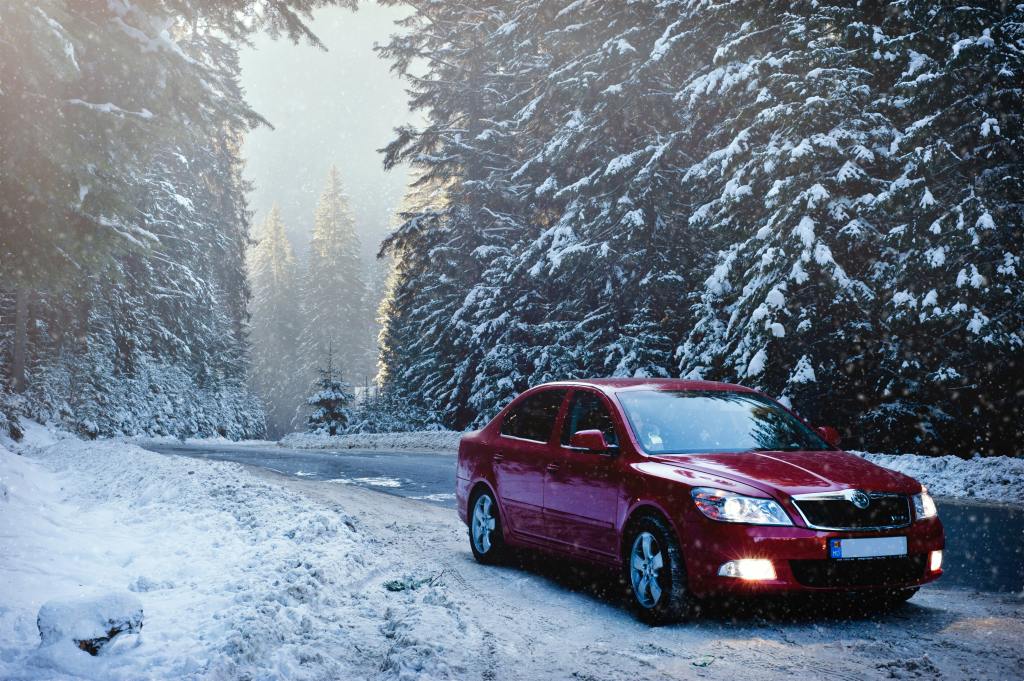A car parked on a snowy road.