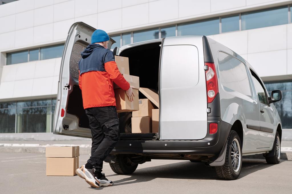 A man loading boxes into a van.