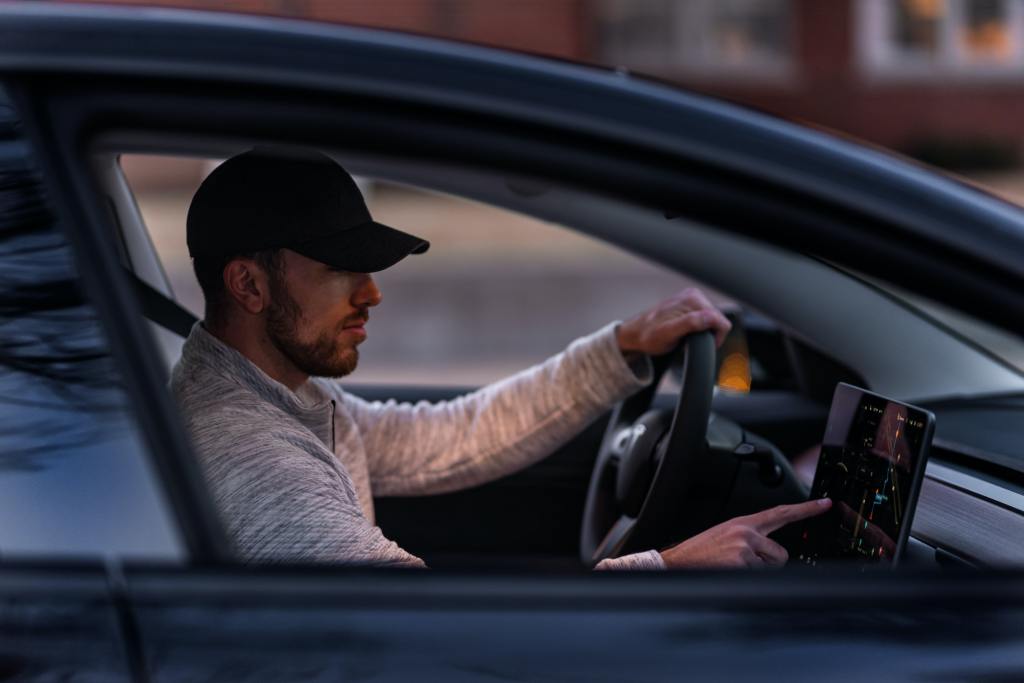 A person driving a tesla.